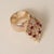 Vintage ruby and diamond navette cluster cocktail ring crafted in rich yellow gold, featuring a bold, raised domed design...