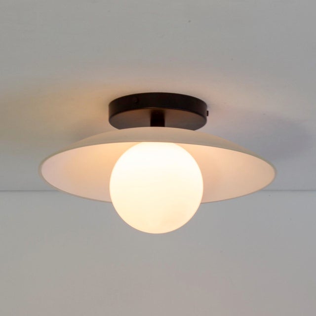 Half-glass, all glow. The Dish Sconce delivers soft light with playful elegance. Feels good on the wall. Materials Steel,...