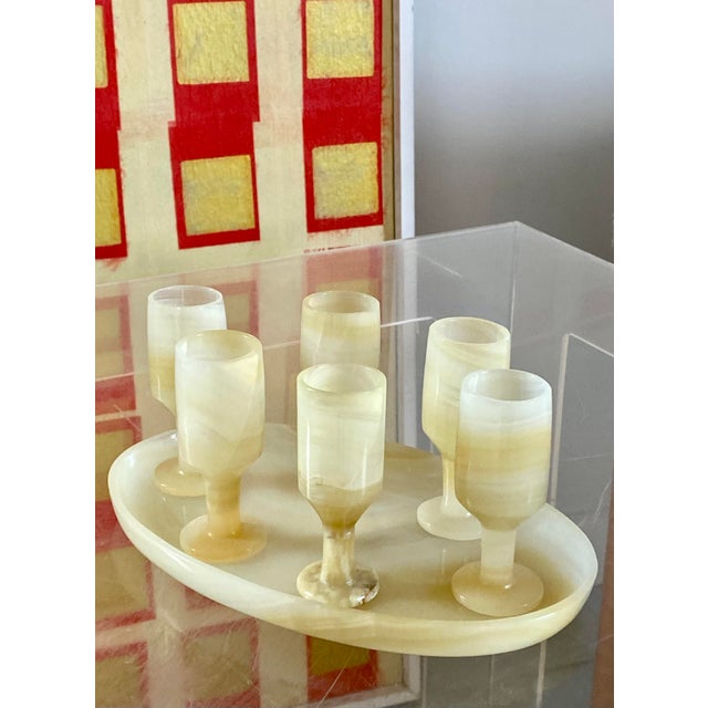 Onyx carved stemware with oval tray. Perfect for special cordials or whatever spirit suits your taste. Carved from richly...