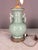 Green celadon color with ornate brass accents. Large fixed rings on both sides. Two bulb antique corded lamp in working...