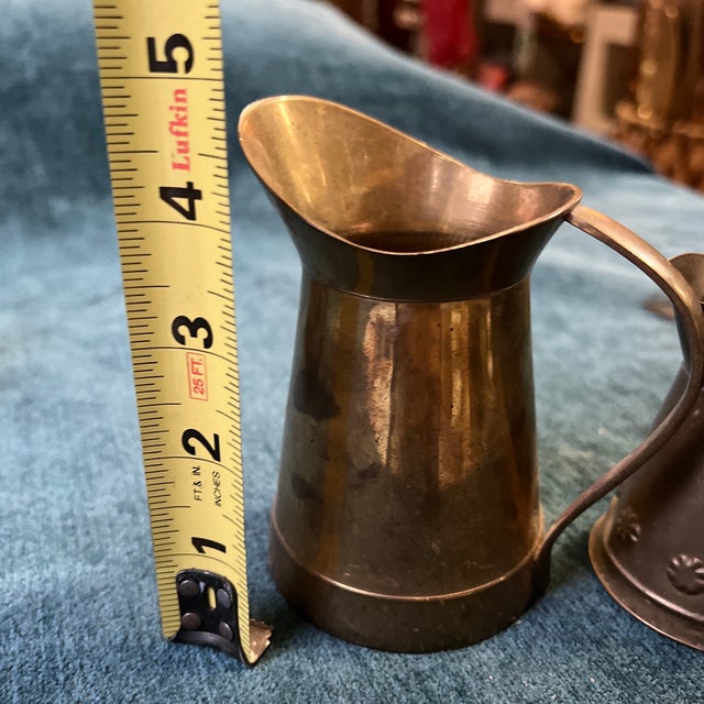 Up for consideration is a beautiful vintage pair of miniature brass pitcher style vases. These would look lovely in your...