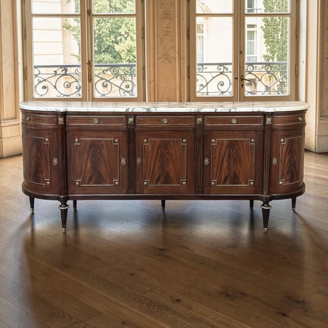 Grand Louis XVI Style Flame Mahogany Buffet with Marble Top has the kind of presence that sets the style for an entire...