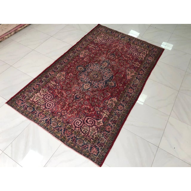 This is a vintage red rug handmade from wool. The piece is one-of-a-kind, with perfect design and colors.