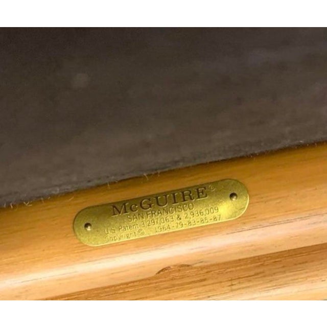 Golden rattan, McGuire target back arm chairs. Upholstered in a designer chinoiserie fabric in pink and olive green. Well...