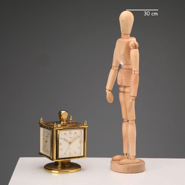 Gold-plated brass table clock with eight-day weather station, alarm, barometer, thermometer, and hygrometer. Swiss-made...