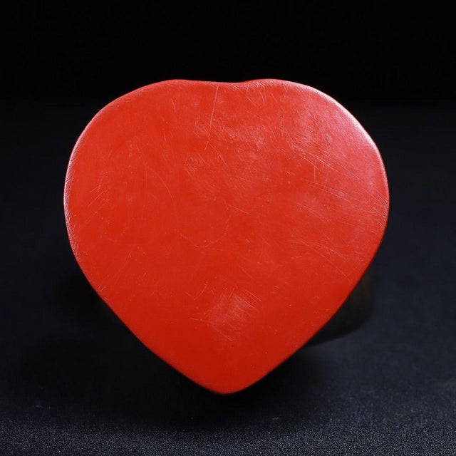 A striking Chinese heart-shaped carved cinnabar lacquer (tihong) box, densely carved in high relief across the lid with a...