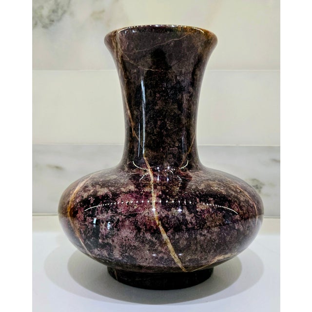 Bring home a vintage polished Bidasar red stone vase with dramatic natural veining and a rich marbled palette of deep red,...