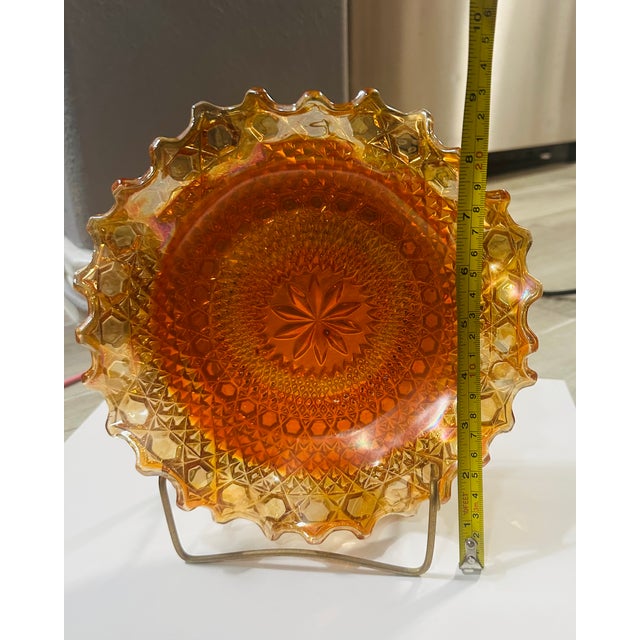 This Vintage Indiana Carnival Marigold Ruffled Diamond Cut Plate is a unique and colorful piece from the early 20th...