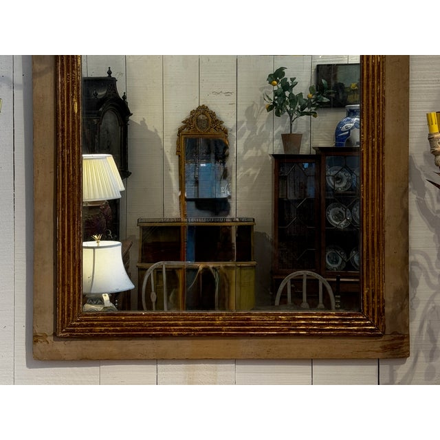 A 19th century Swedish mirror with a wide rectangular frame finished in painted surface with a gilt inner molding. The...