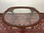 This oval glass-top coffee table brings a clean, open feel to a living room while still offering the warmth of a classic...