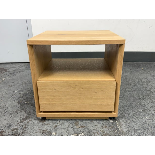 Design Plus Gallery presents the Norre Nightstand from Williams Sonoma Home. This light oak veneer nightstand has a square...