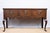 An antique oak console or dresser base, c. 1860, English. Featuring three drawings with original brass hardware and a...