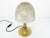 Sculptural table lamp composed of a brushed gold brass base and Murano molded blown glassware, translucent with satin...
