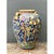 This vintage Italian terracotta urn presents a grand, bulbous silhouette, swelling generously from a narrow foot to a...