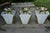 Mid Century Modern set of three flush mount ceiling fixtures with frosted white glass and gold metal frames. Each light...