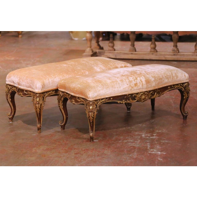 Hand-carved in France circa 1860, this pair of antique Louis XV benches is crafted in solid walnut with a painted finish...