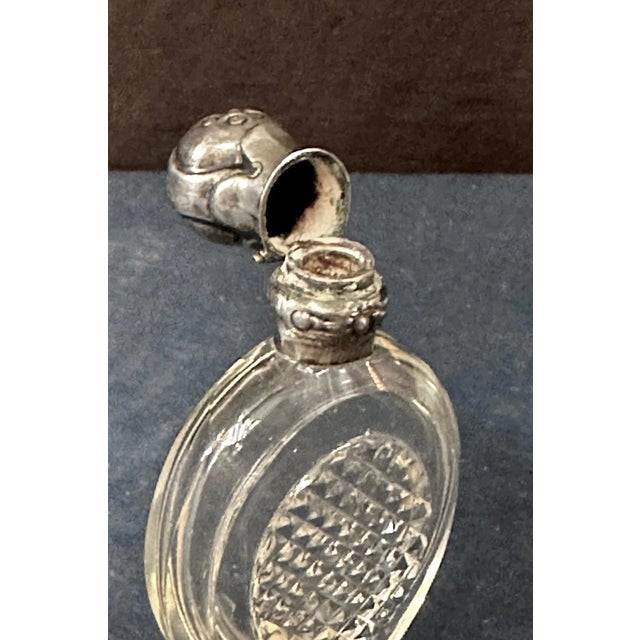 This vintage Continental 19th century scent bottle is designed in silver & crystal. Its unique shape exhibits a sparkling...