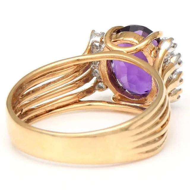 This dazzling, vintage-style, 10K yellow gold ring, with its gorgeous oval-shaped amethyst surrounded by eight sparkling...
