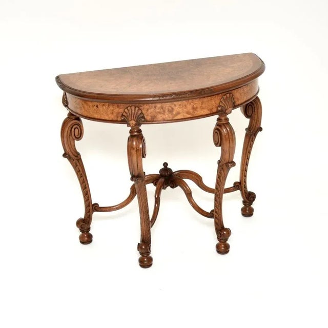 A stunning antique burr walnut console side table by Maple and Co. This was made in England, it dates from around the...