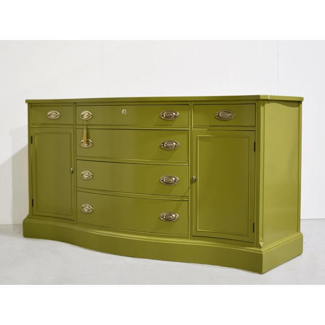 Mid century Federal style credenza by Bassett Furniture, newly painted in Forest Moss by Benjamin Moore, has a serpentine...