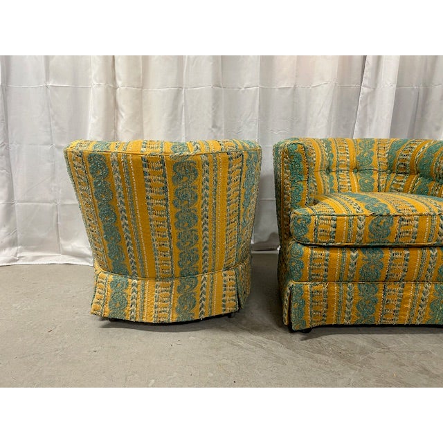 Chic pair of vintage barrel chairs on castors to float in your space.