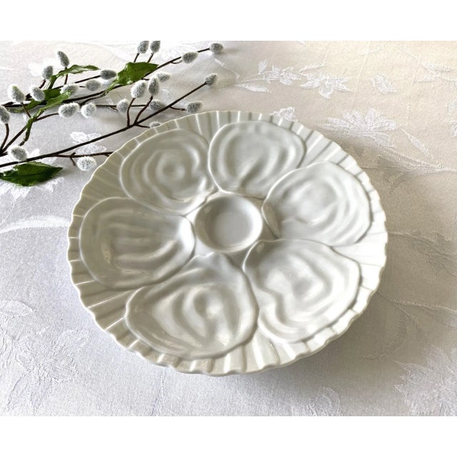 6-Well Blanc Porcelain Oyster Dish with Center Well 9.25" Unmarked A beautiful simplistic blanc porcelain in an off-white...