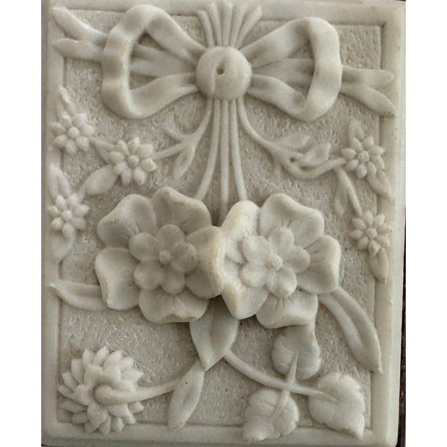 Beautiful hand carved flower plaque from the 19th century. The sculpture is attched to a purple marble for display. A...