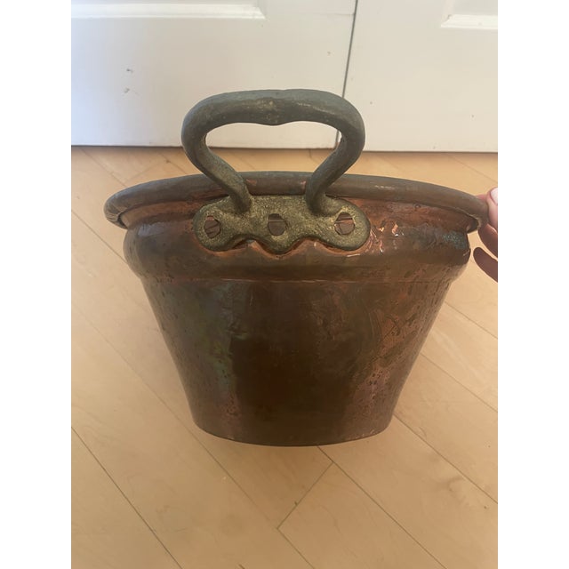This antique primitive copper basin bucket features a unique dovetail cramp seam design along the bottom, adding to its...