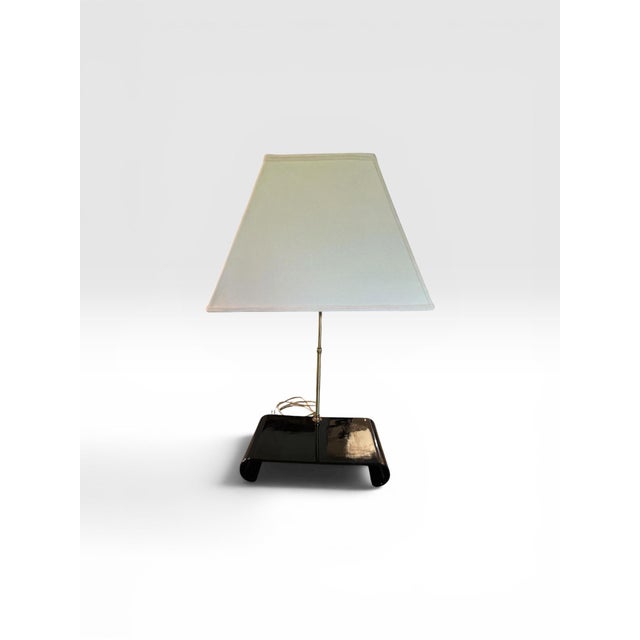 An elegant vintage Toyo Japan table lamp featuring a striking high-gloss black lacquer waterfall base paired with a...