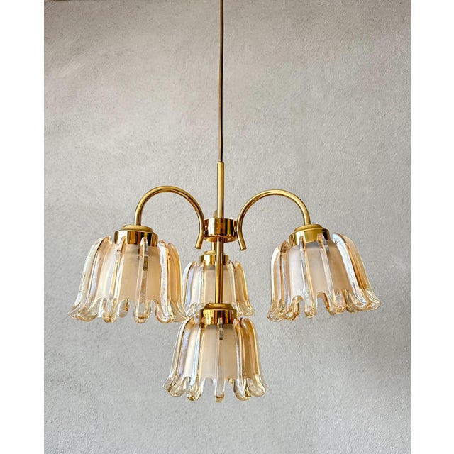 This vintage amber pendant lamp adds a touch of elegance to any room. with its beautiful glass shades and gold metal...