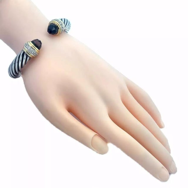 This authentic bracelet is by David Yurman from the Cable Collection, the 10mm thick cable band is hinged on the back...