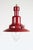 Red metal pendant light with industrial nautical style. Single light fixture with red exterior and brass details and a...
