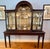 A meticulously crafted antique Chippendale style carved mahogany two-part display china cabinet with a distinctive arched...