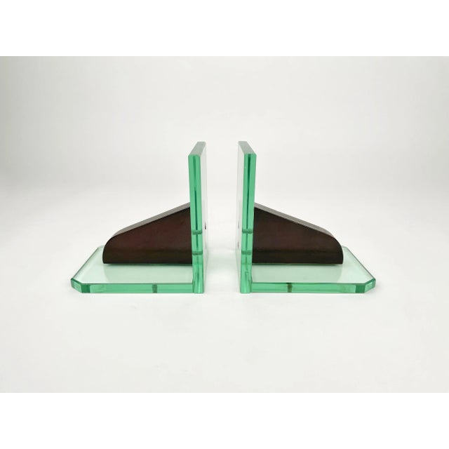 Pair of bookends in aquamarine glass structure and wood in the style of Fontana Arte. Made in Italy in the 1950s.