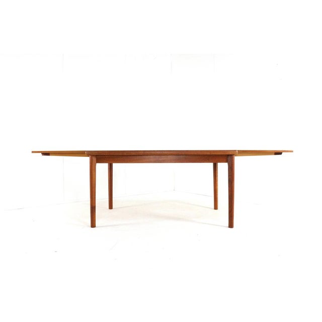 Beautiful refurbished teak dining room table in clean condition. The table can be extended by an ingenious system. Under...