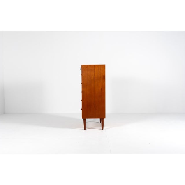 A classic Danish tallboy chest from the 1960s, crafted in warm teak with a beautiful natural grain. The six spacious...