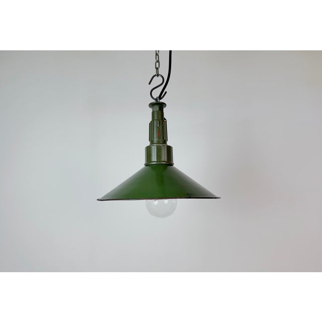 Industrial green enamel pendant light made in Poland during the 1960s. White enamel inside the shade. Green cast aluminium...