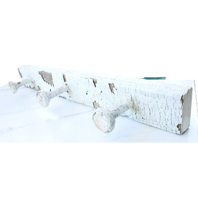 1920's antique French hat/coat rack, made of carved wood. We love the original distressed craquelle white paint. There are...