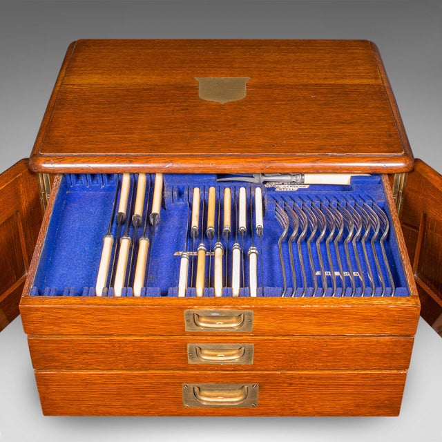 This is a superb antique cutlery canteen. An English, oak three drawer storage case with silver plated flatware by Walker...
