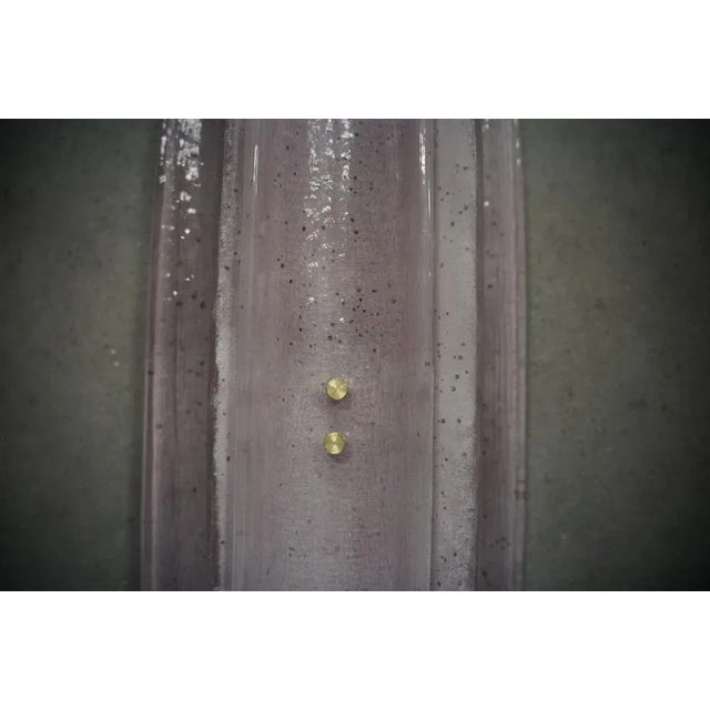 Very original Murano glass wall lamp with a very elongated design of the glass half shell and a unique pink colour. The...