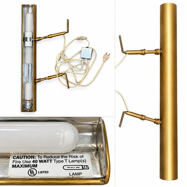A timeless brass picture light featuring a clean, architectural design. Its slender cylindrical shape and adjustable arms...