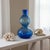 Add striking color and sculptural form to any interior with this vintage hand-blown translucent blue art glass vase. Its...
