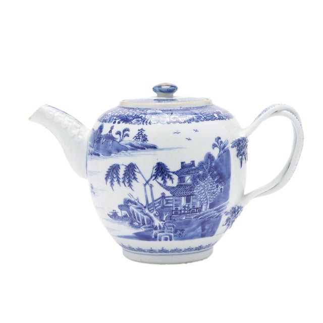 Chinese export porcelain globe tea pot with lid and twisted strap handle. The pot is decorated in underglaze blue with the...