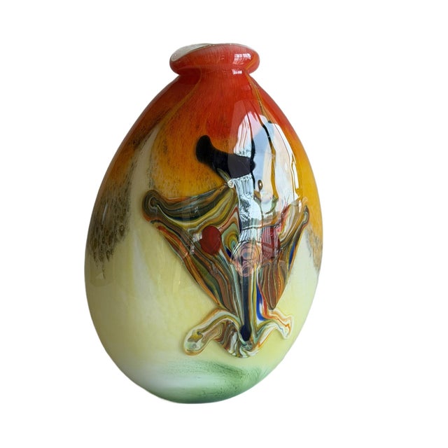 This hand-blown art glass vase represents the mid-to late 20th century studio glass movement, which emphasized artistic...