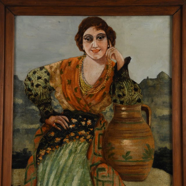 This Framed Signed Portrait of a European Woman Oil on Canvas depicts a confidently posed figure seated beside a large...