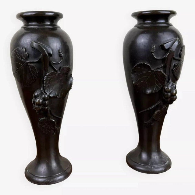 Pair of Art Nouveau bronze vases with a black patina, featuring slender forms and decorated with high-relief naturalistic...