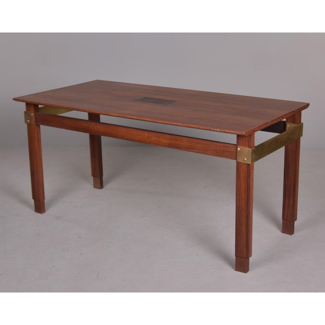 Found in Italy, this mahogany and brass dining table dates from the 1970s. Table features nicely figured top with...