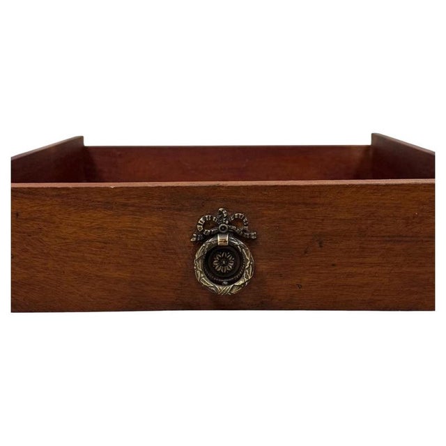 A handsome and beautifully proportioned 20th-century mahogany writing table, combining elegant traditional styling,...