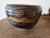 Rustic studio pottery bowl. This rustic bowl is glazed in an earth tone color palette and has a wavy swirl design. Very...