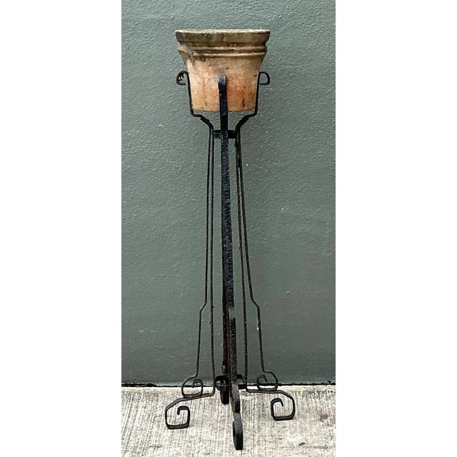 This vintage hammered iron and cement planter stand, attributed to Wells, brings a substantial architectural presence to a...